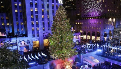 
              FILE - In this Wednesday, Nov. 28, 2012 file photo, the Rockefeller Center Christmas tree is lit during the 80th annual tree lighting ceremony at Rockefeller Center in New York. Comcast